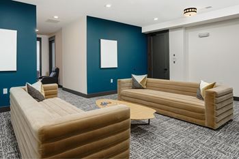 A room with two couches and a chair.